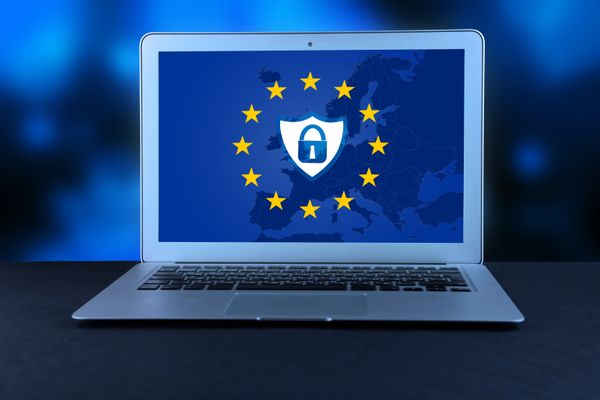 Image of a macbook laptop with the EU GDPR background on the screen
